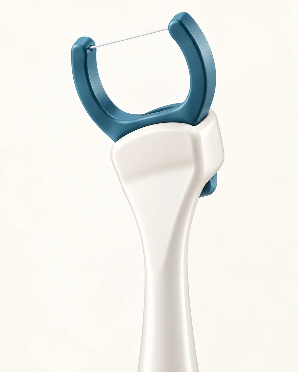 Close-up of floss held between the head’s two prongs